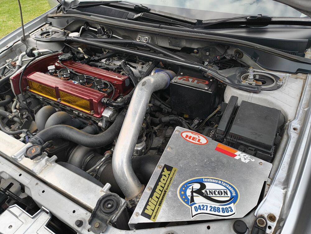 Engine bay from the airbox side — HEL, K&N, Winmax stickers visible on the engine cover