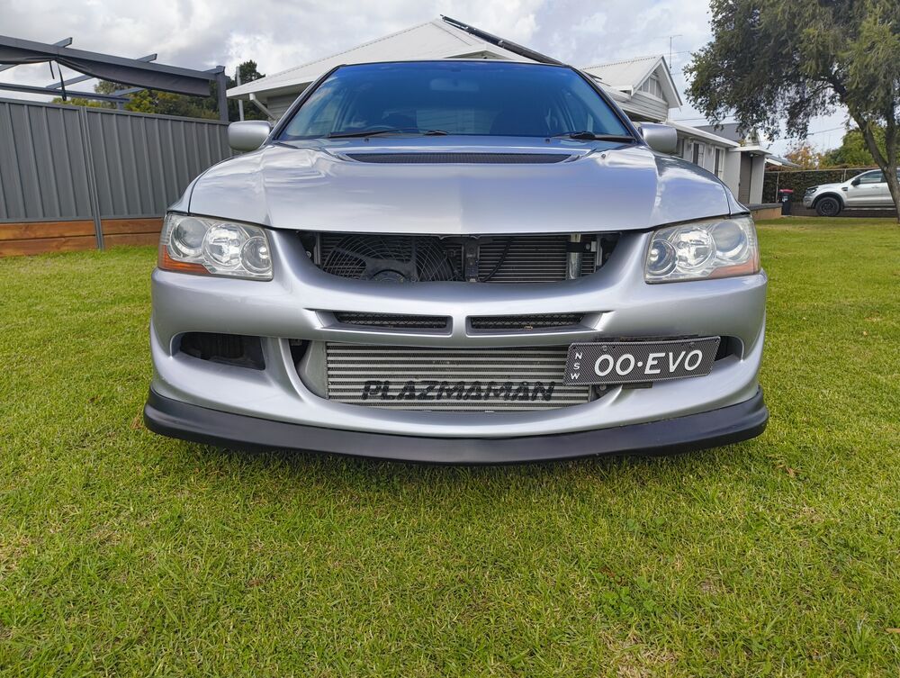 Dead-on front — Plazmaman Race Series intercooler visible through the bumper, 00·EVO plate